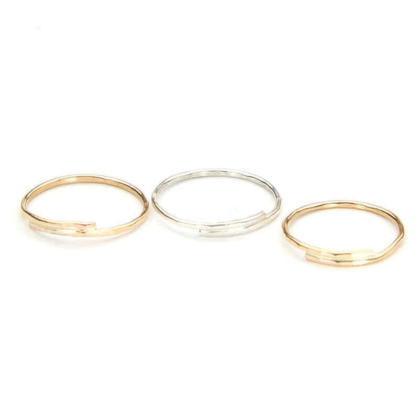 Trio of assorted gold and silver hand-hammered rings.