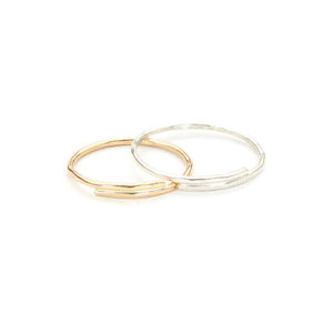 Hand-hammered gold band and silver band ring.